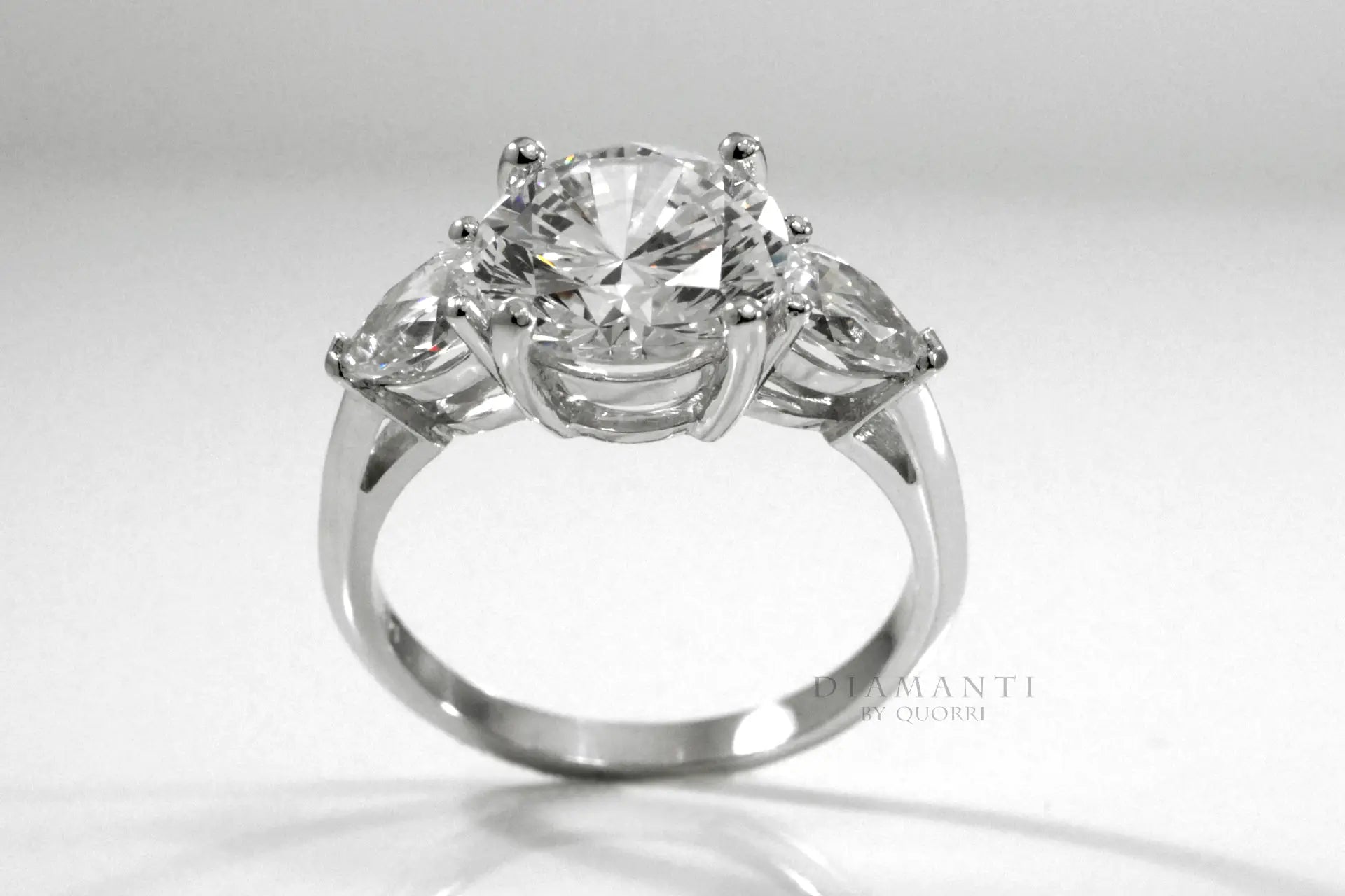 affordable three stone 3ct round and pear accented lab made diamond engagement ring