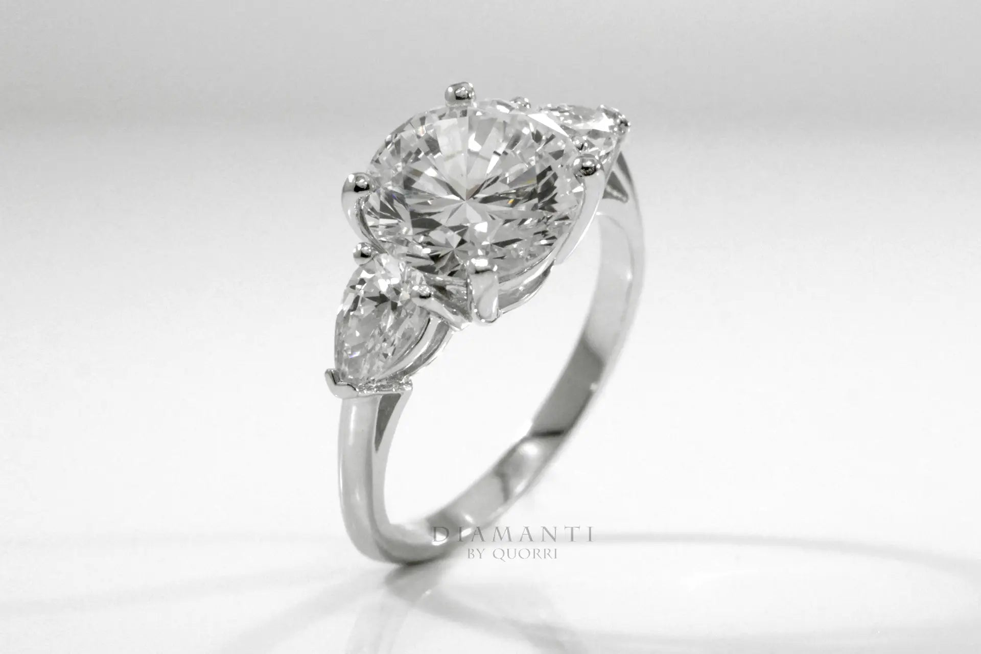 3 carat three stone round and pear accented lab created diamond engagement ring Quorri