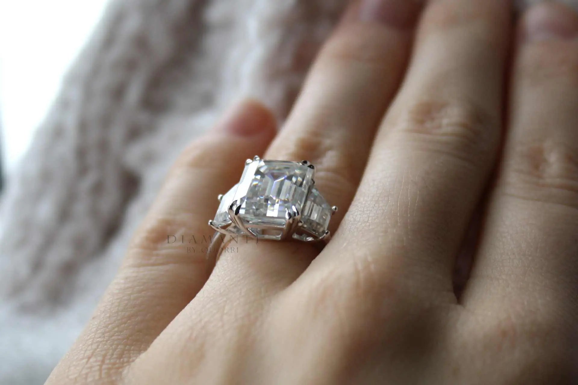 dual claw 4 carat emerald and trapezoid 18k white three stone lab diamond engagement ring quorri