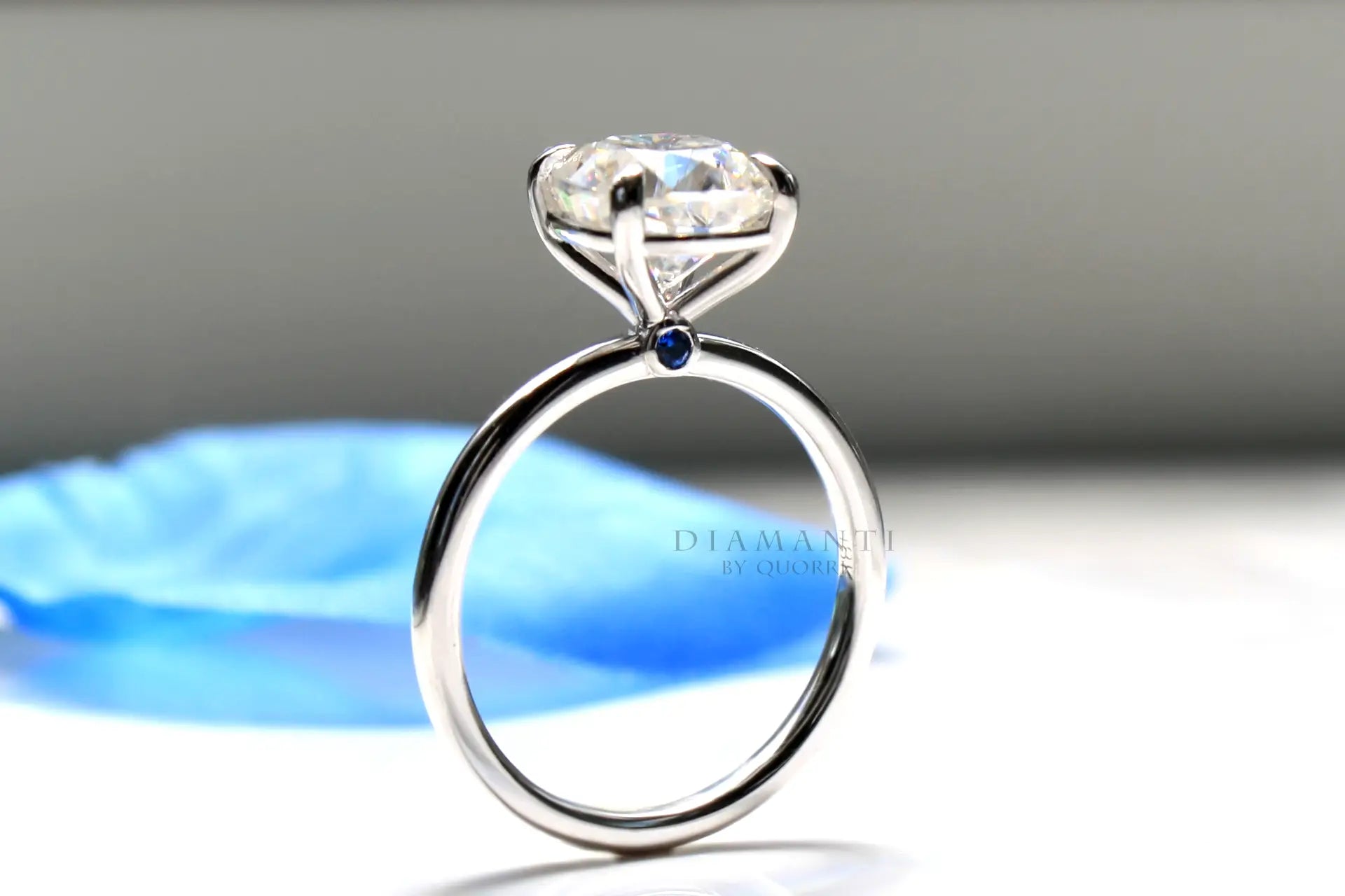 2.5 carat blue sapphire accented claw prong white gold cushion lab diamond engagement ring Quorri 