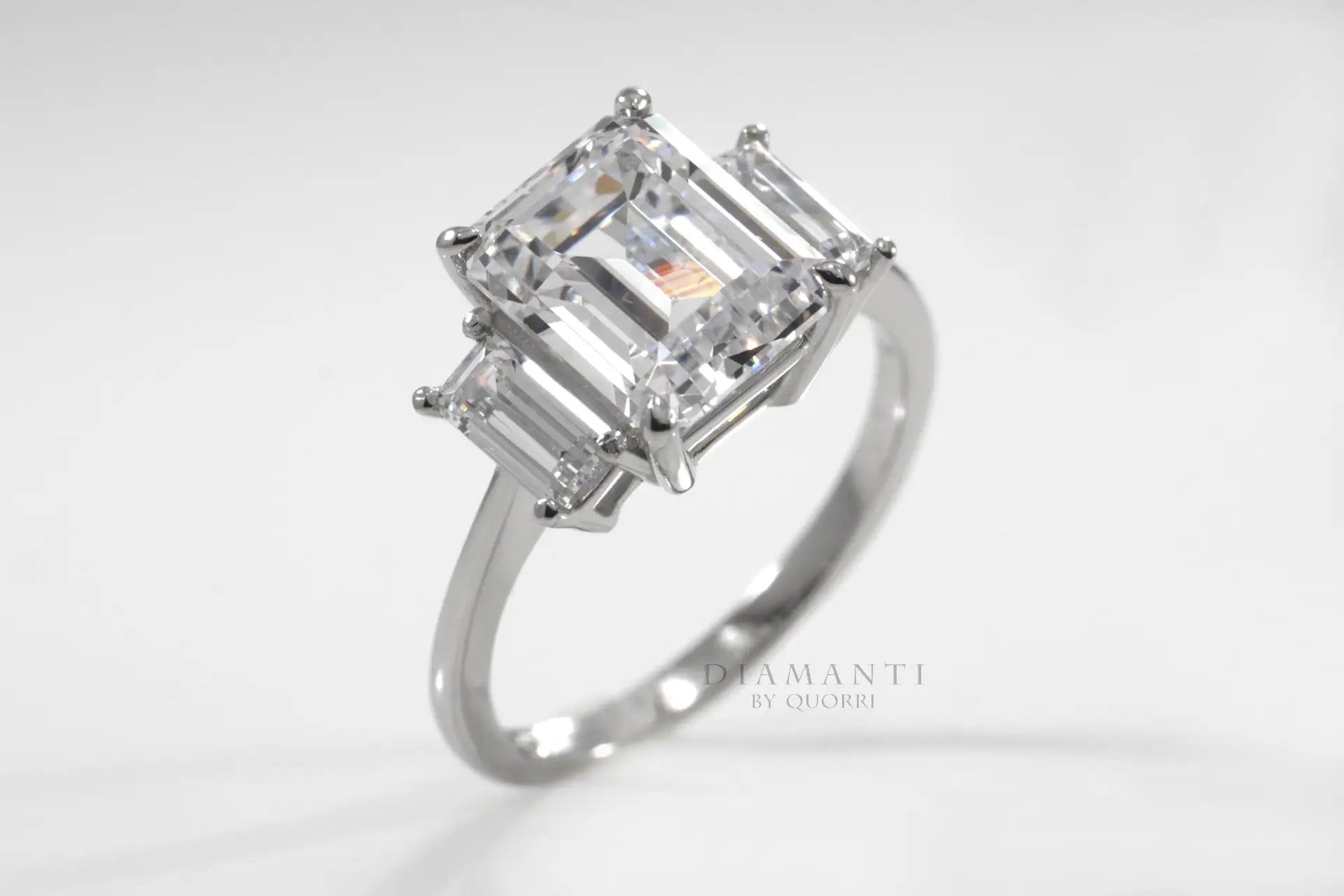 three stone claw prong emerald lab diamond engagement ring