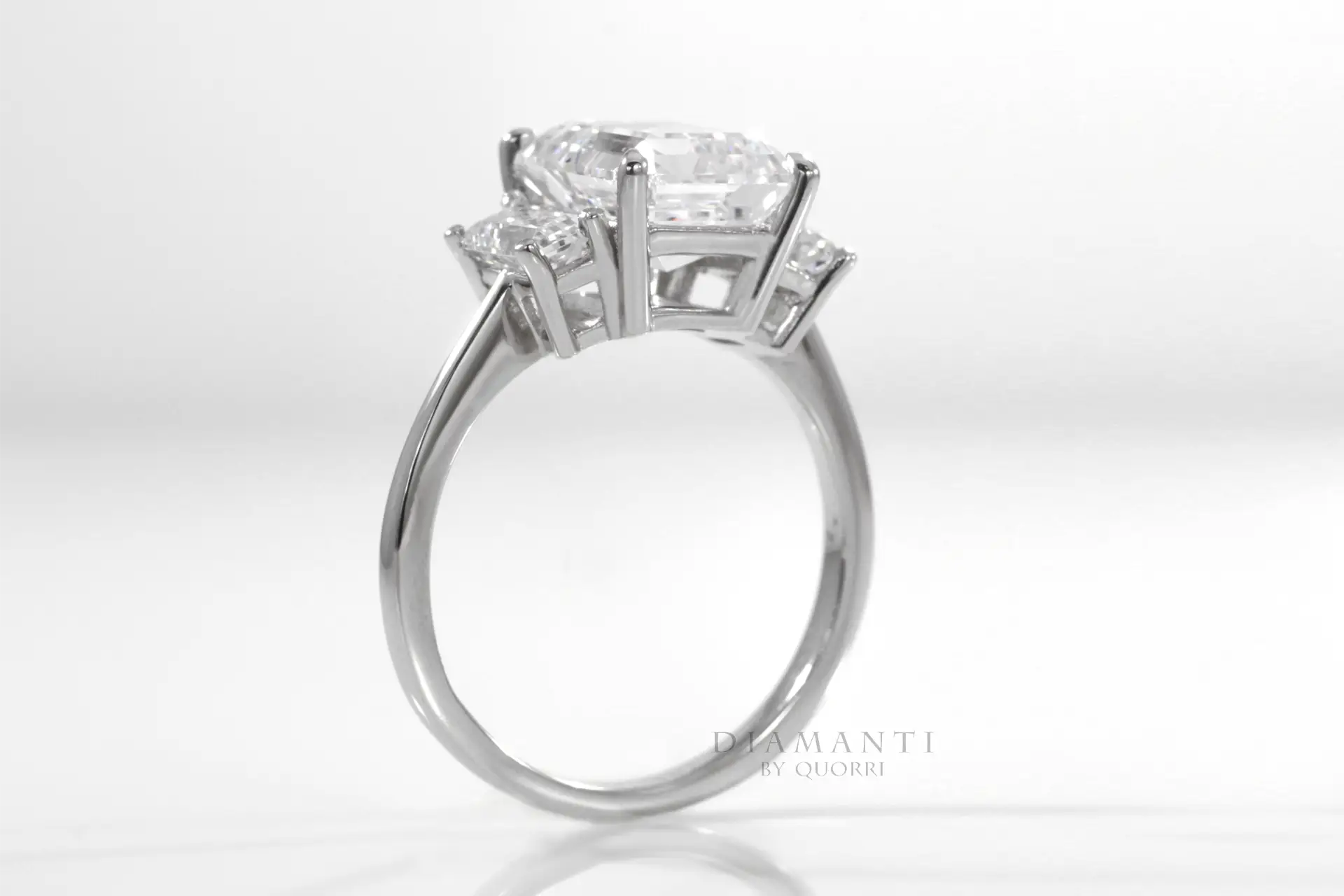 platinum three stone claw prong emerald lab diamond engagement ring Quorri