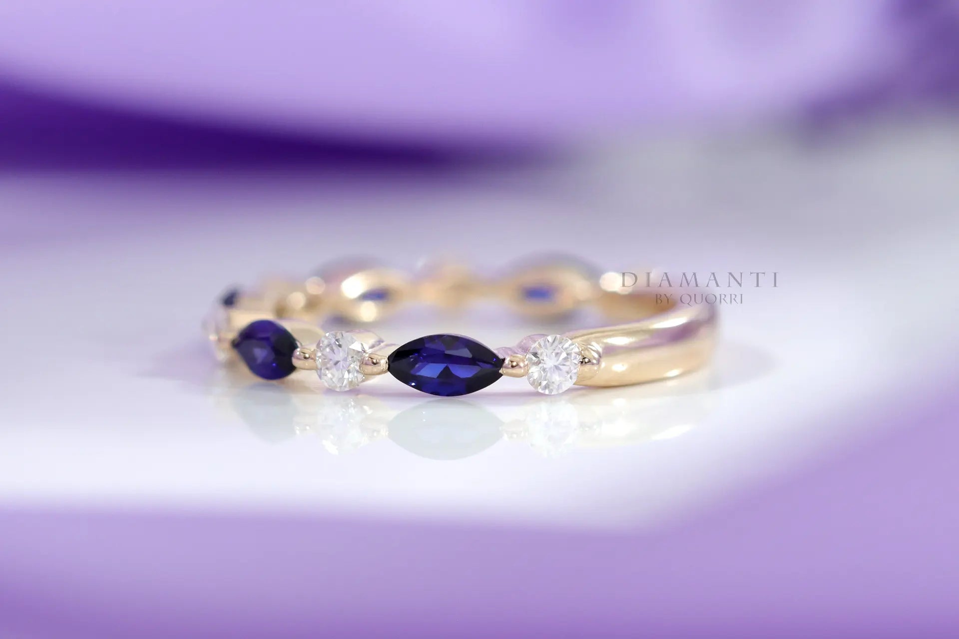 designer yellow gold alternating white diamond and blue sapphire wedding band Quorri